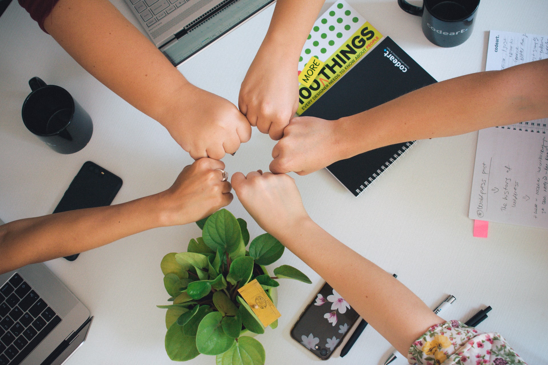 five-people-putting-their-fists-into-the-centre-together